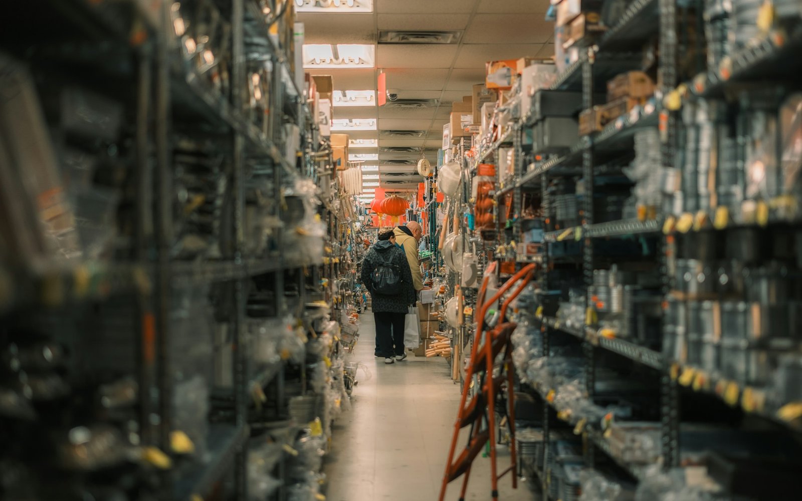 A stocked merchandise aisle with a broad range of household goods