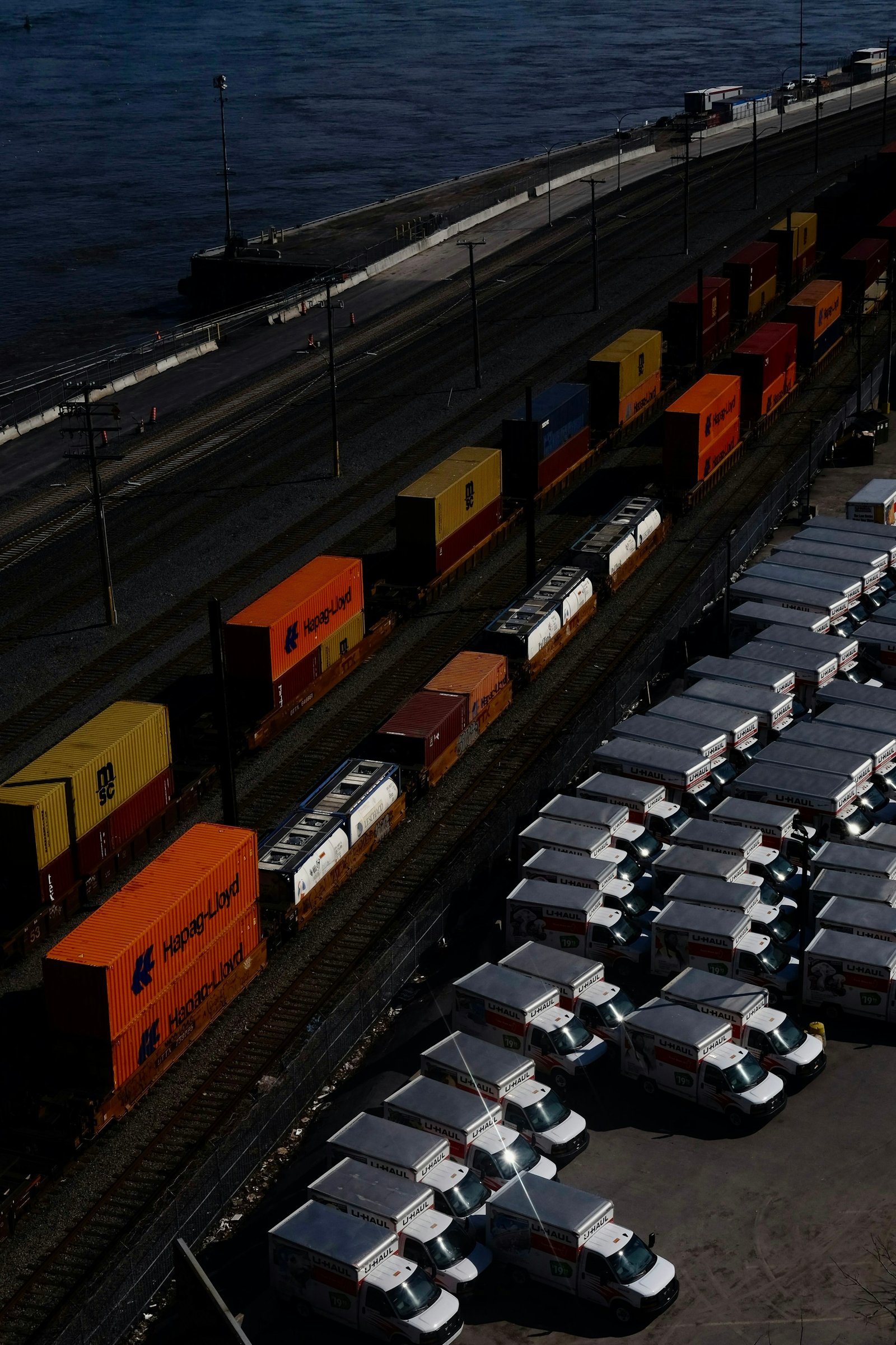 Freight containers arranged beside rail lines at a trade terminal