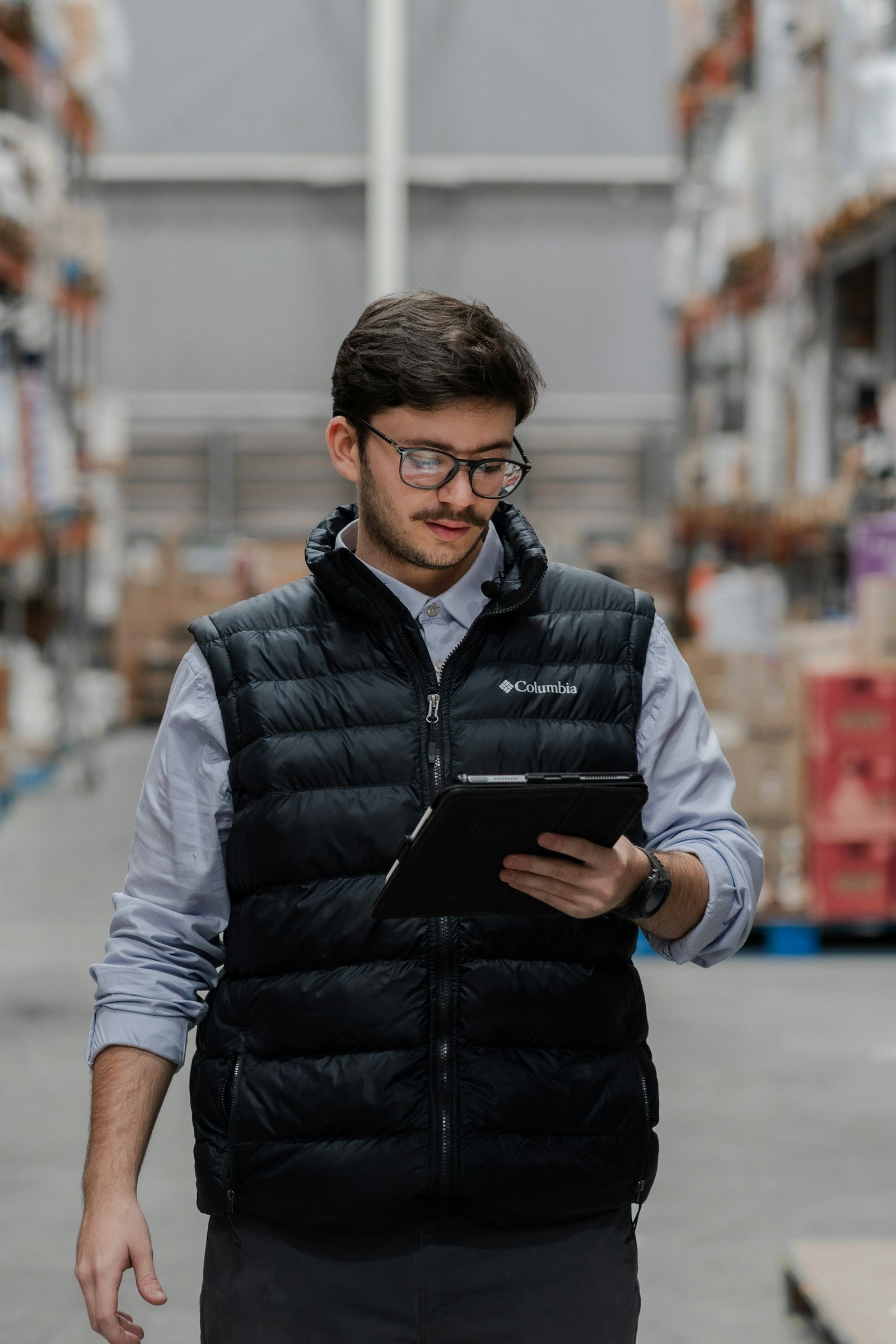 A warehouse operator reviewing transaction details on a tablet